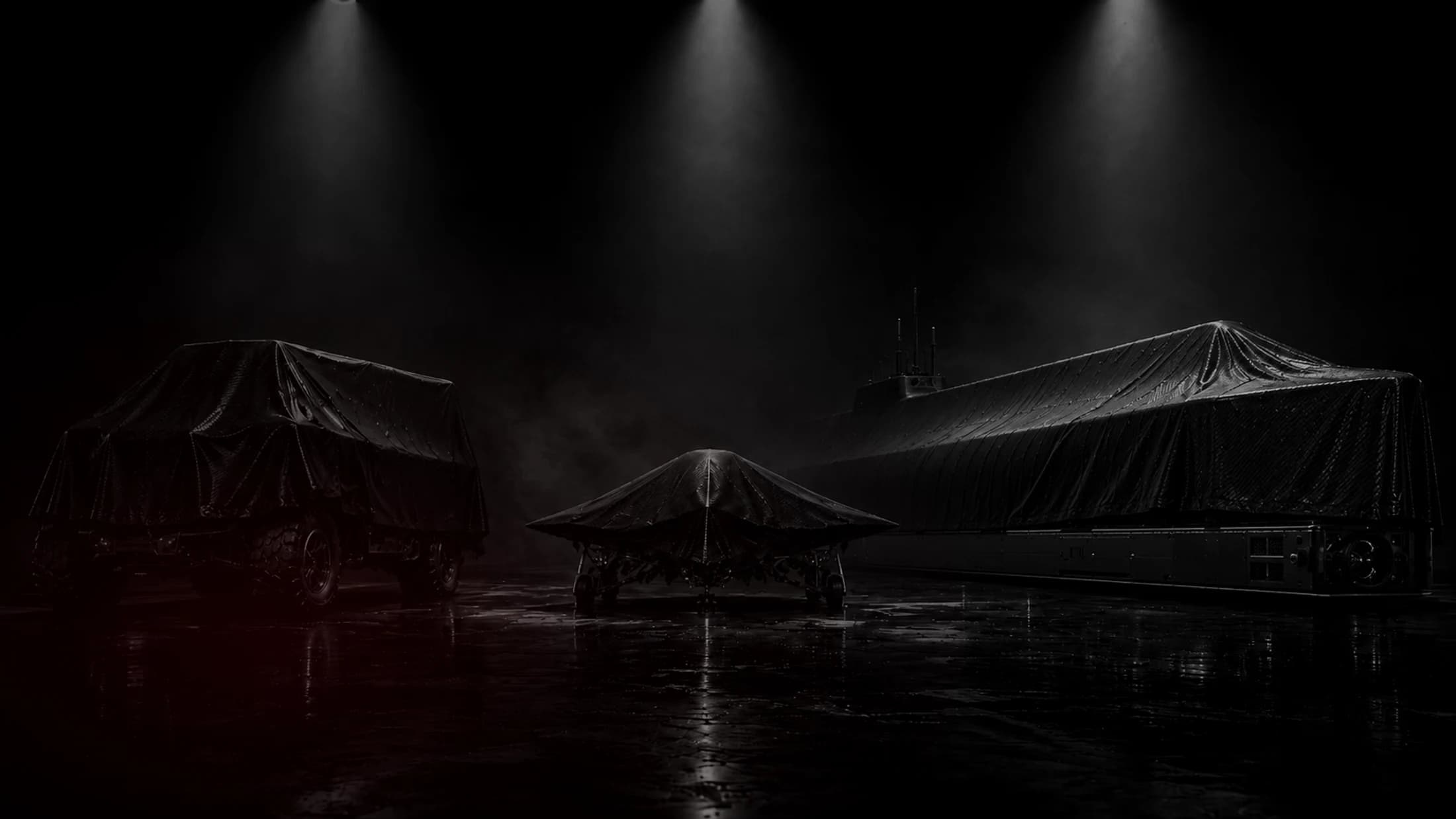 A dark development hangar visual with covered defense industry platforms.